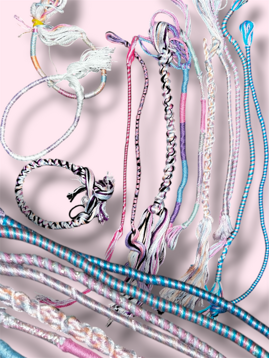 Vaguely Trans Pride themed thread bracelets